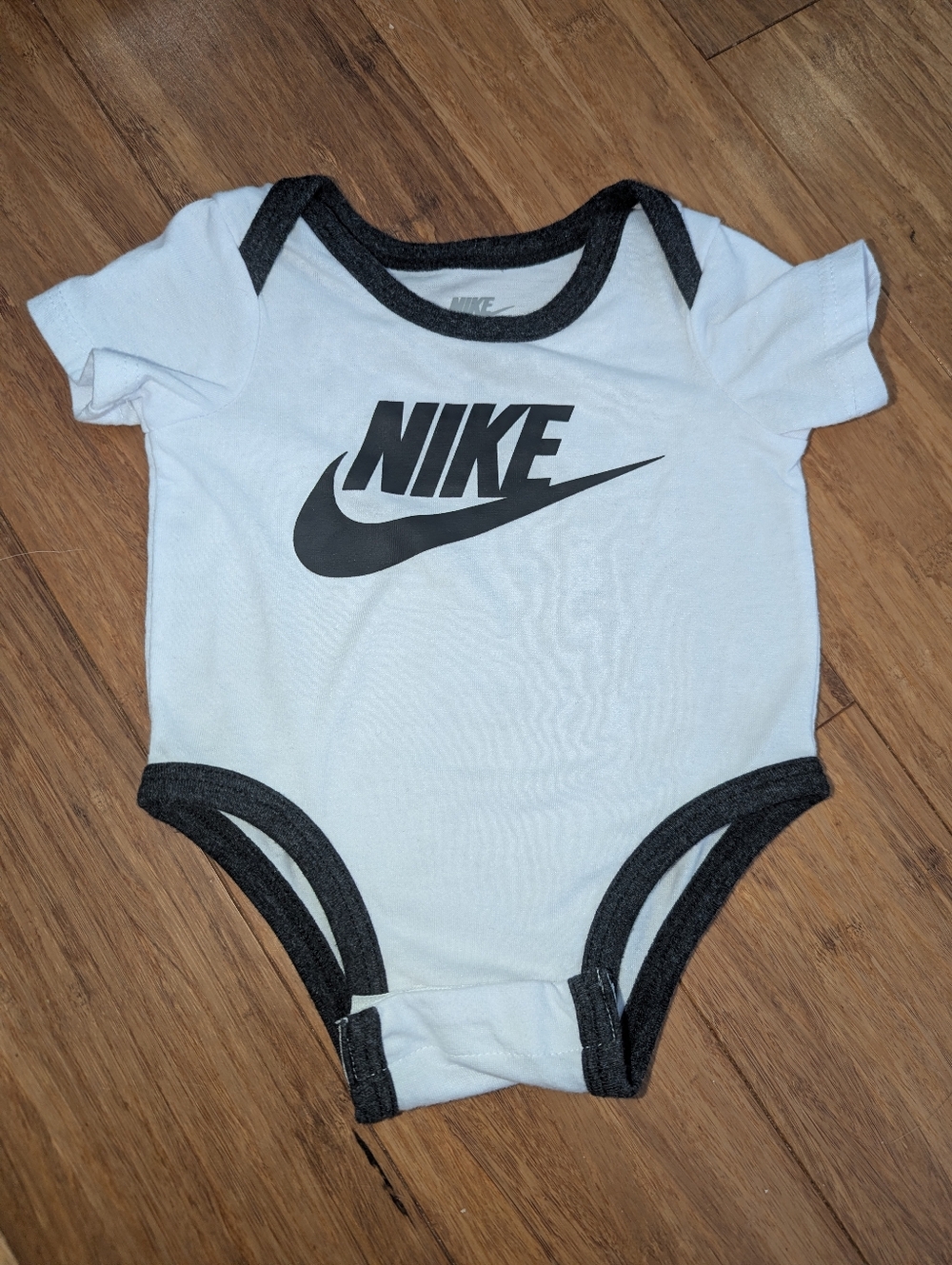 Nike Newborn, White and Black Baby One-Piece gender neutral Bodysuit